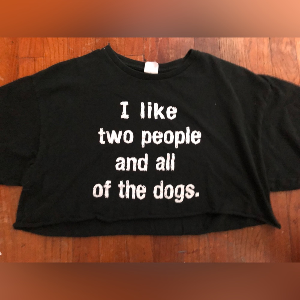 A black crop top that says “I like two people and all of the dogs.”